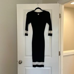 Black sweater dress with white detailing.